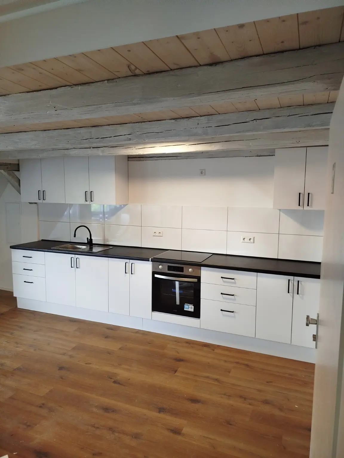 Kitchen beneath historic beams — Overall view