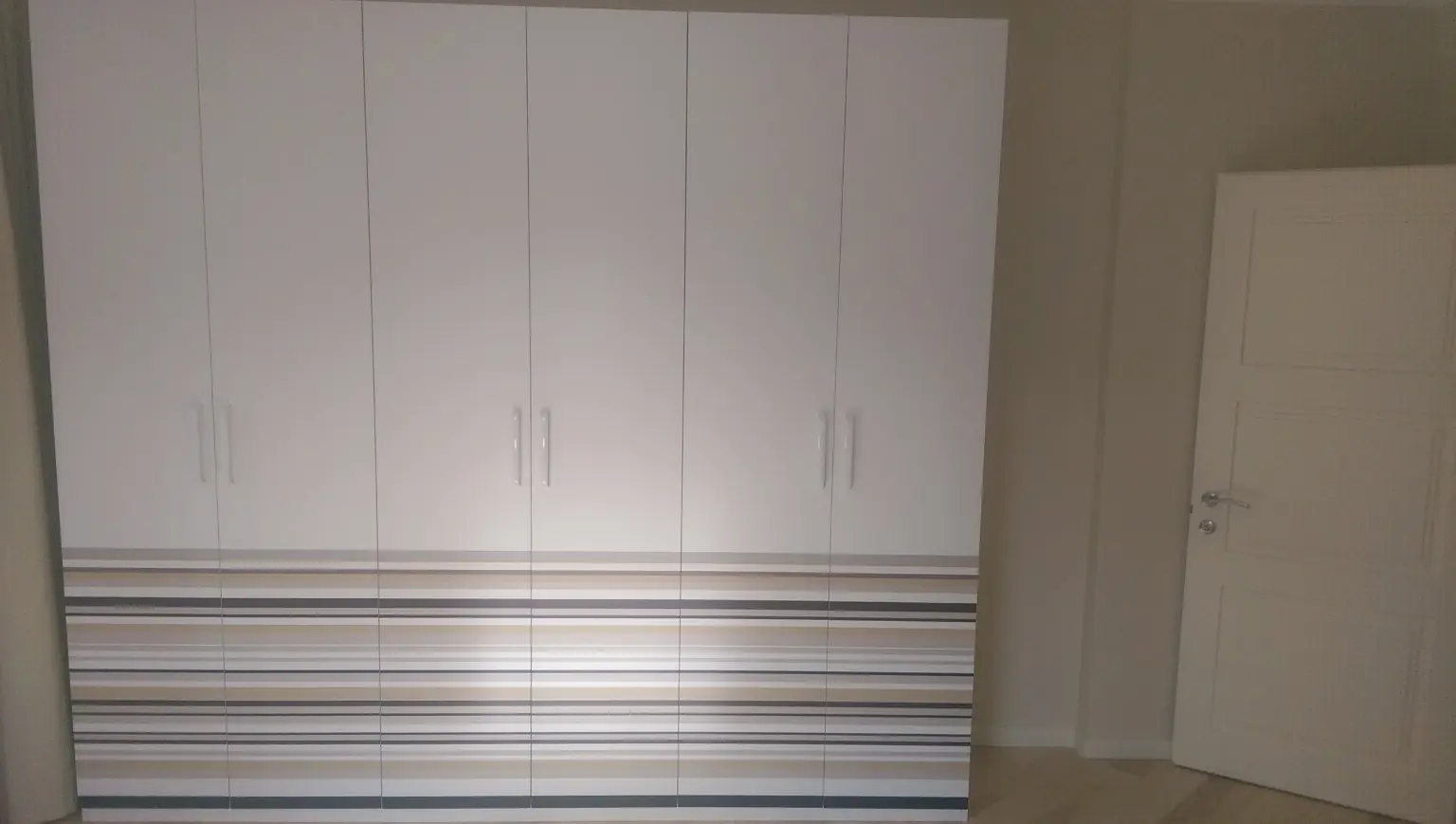 White bedroom with striped detailing — Overall view